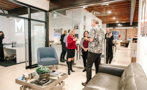People stand in a modern office, talking