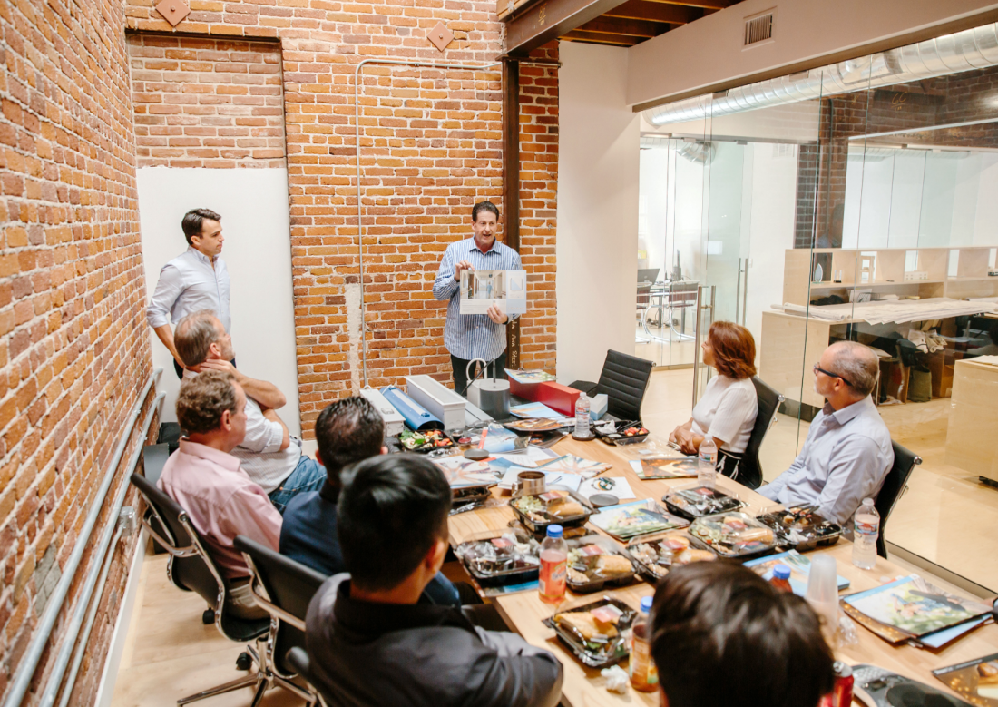 A group of people in a brick conference room